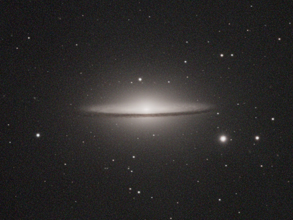 The Sombrero Galaxy with its bright core and dark equatorial dust lane