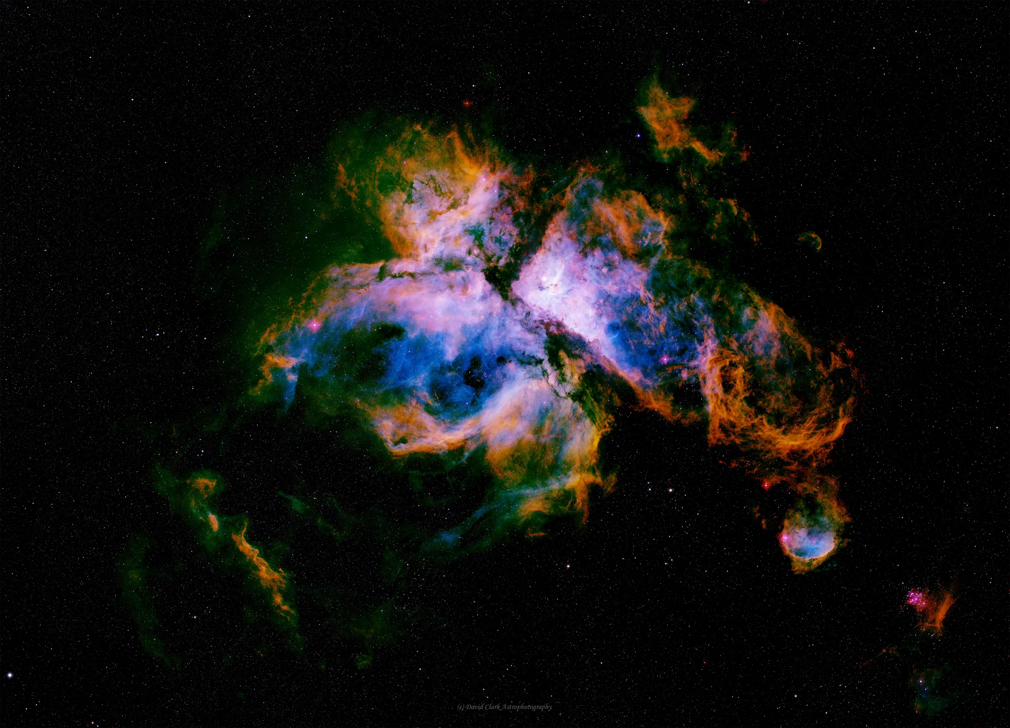 A wide mosaic of the Carina Nebula rendered in vivid blue, gold and violet